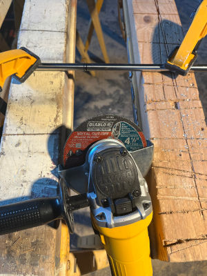 Clamped Axel and angle grinder with 4.5 inch cut-off blade
